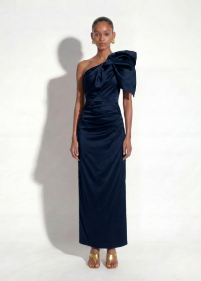 Navy satin one-shoulder gown with a dramatic bow detail and ruched skirt by Alexandria By Elle Zeitoune.